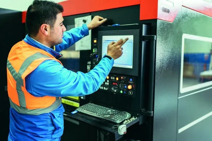 Operator programming a laser cutting machine